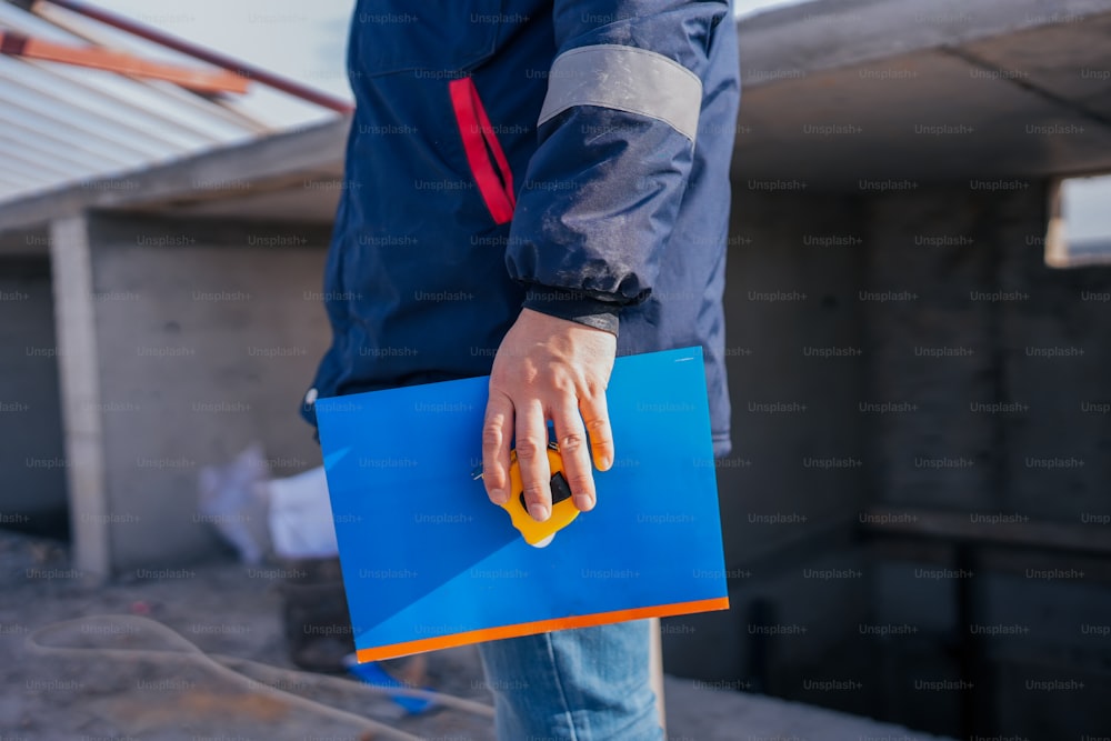 a person holding a blue folder in their hand