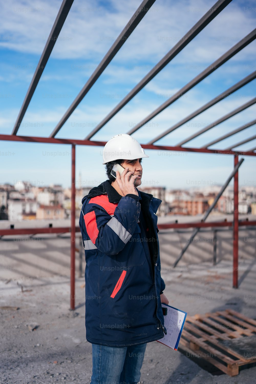 a man wearing a hard hat talking on a cell phone