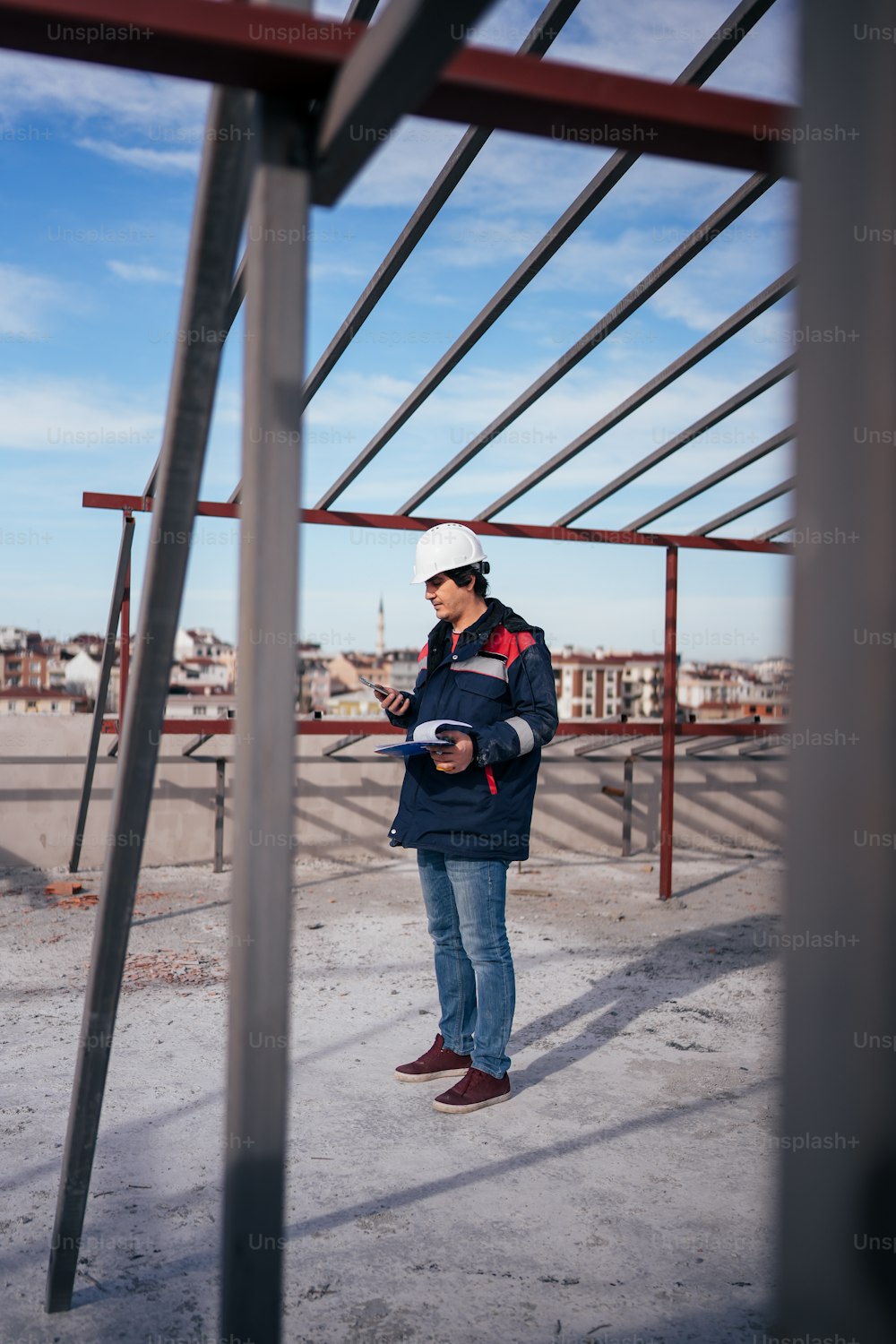 a man standing on top of a roof next to a metal structure