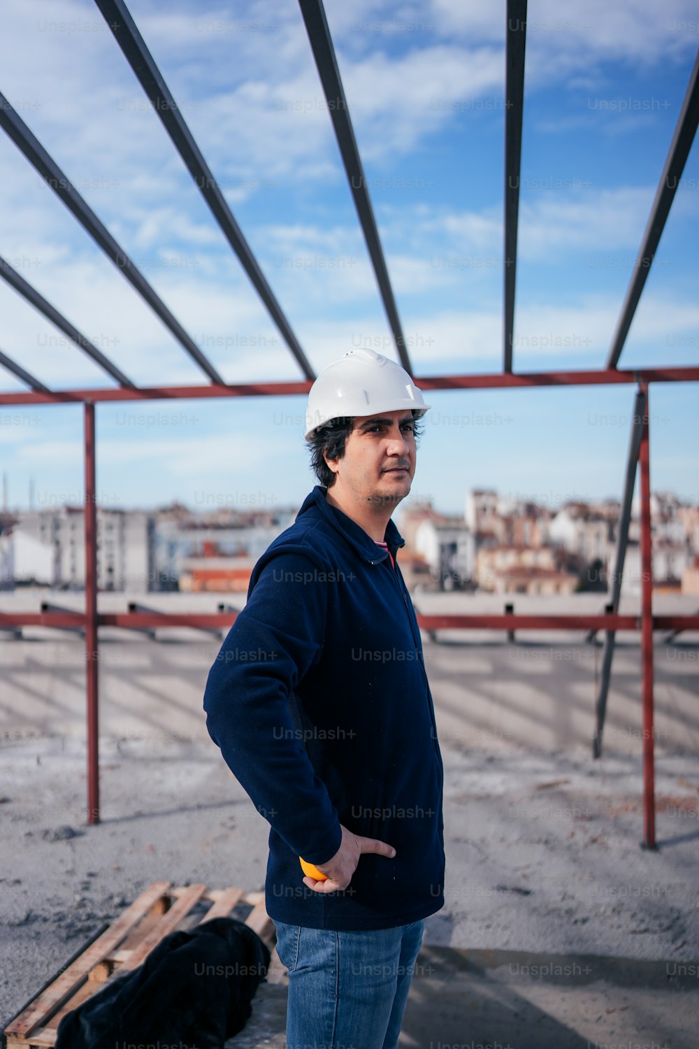 a man wearing a hard hat standing in front of a building