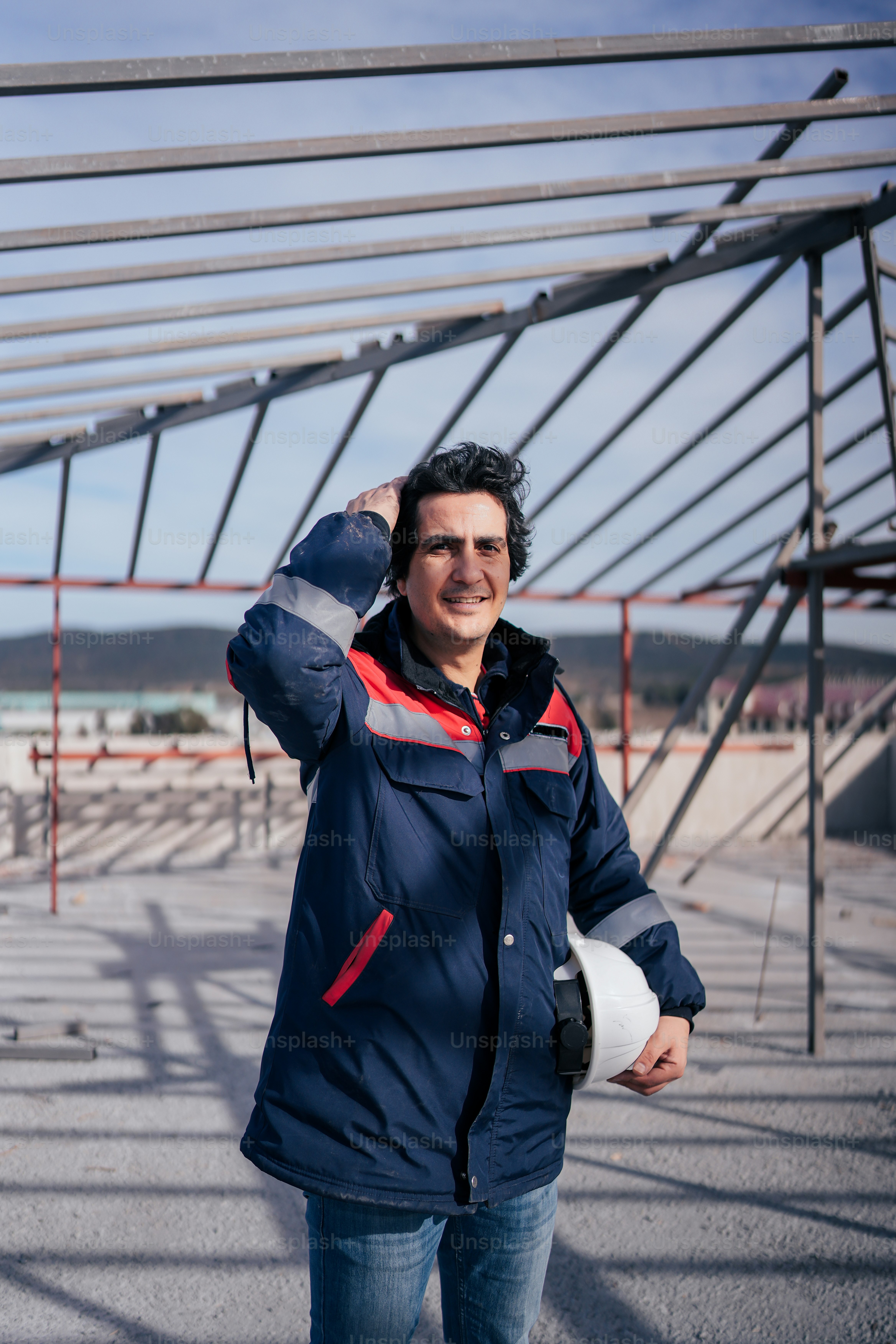 A man standing in front of a metal structure photo – Professional Image ...