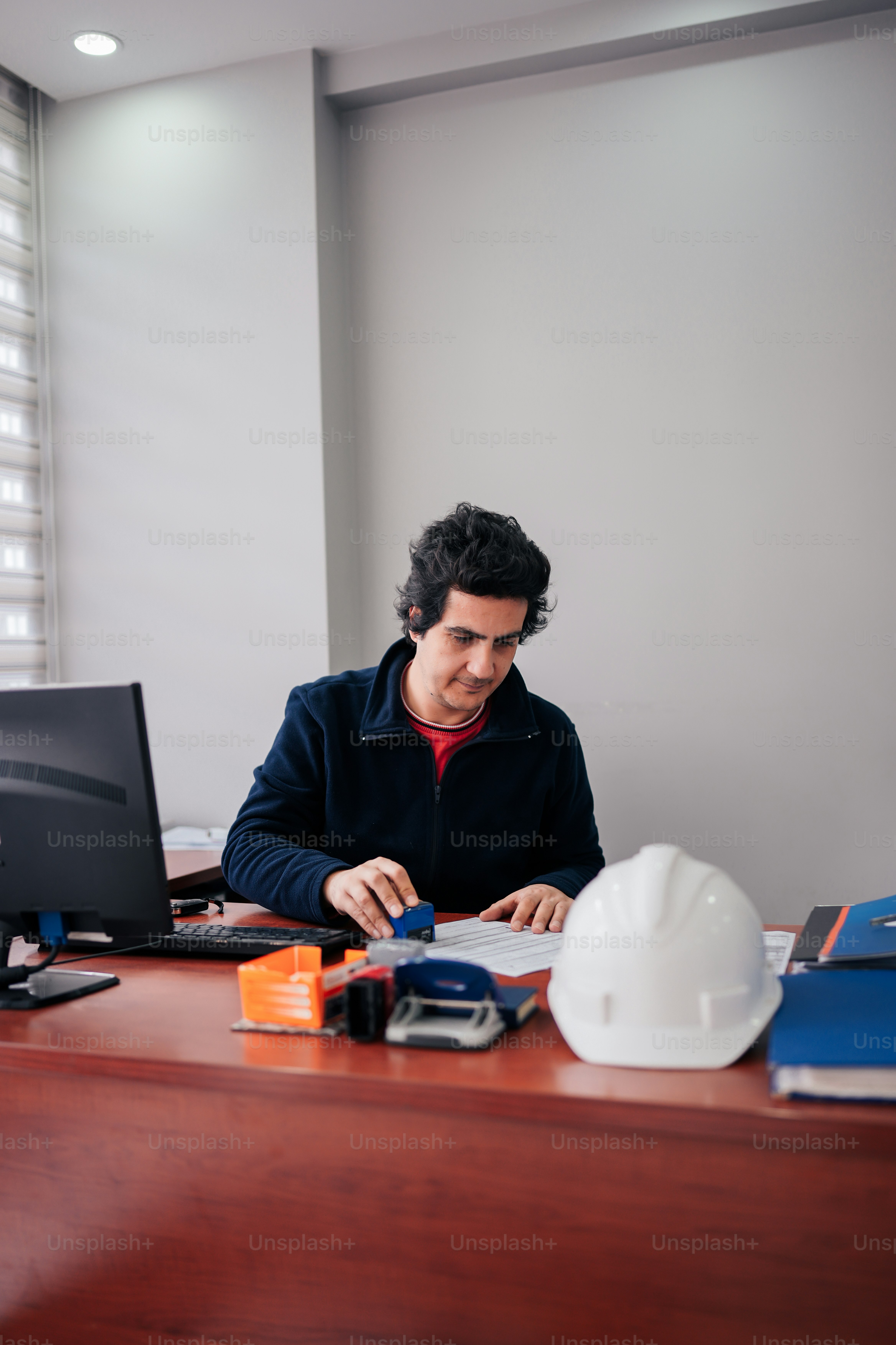 a man sitting at a desk in front of a computer
