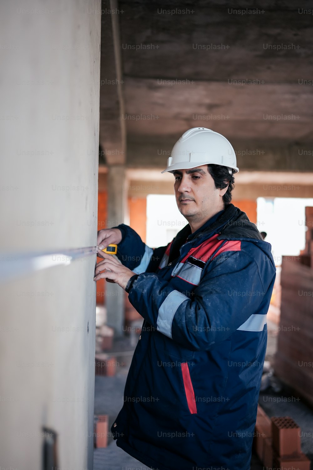 a man wearing a hard hat and jacket