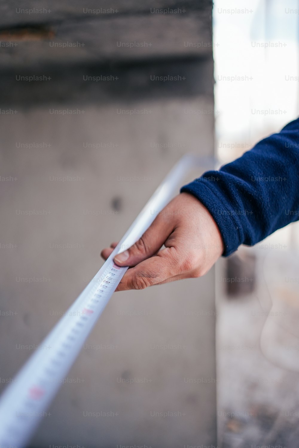 a person holding a measuring tape in their hand