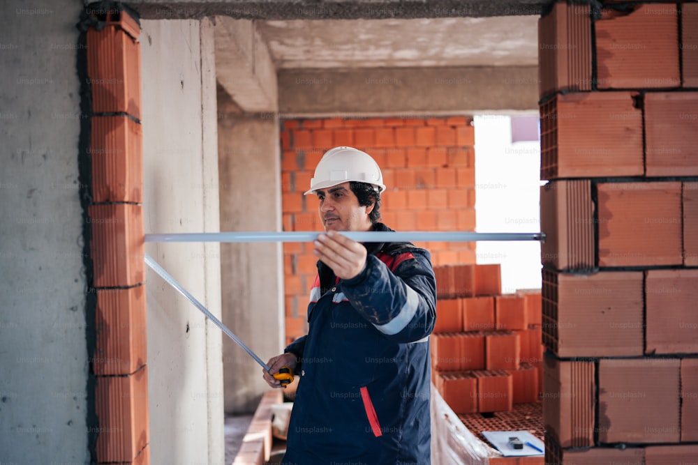 a man wearing a hard hat and holding a hammer