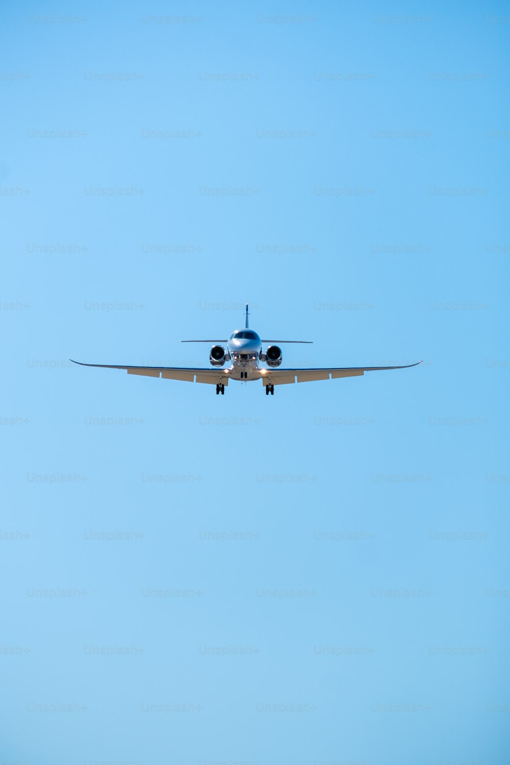 a large airplane flying through a blue sky