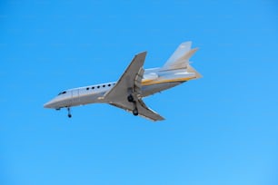 a small plane flying through a blue sky