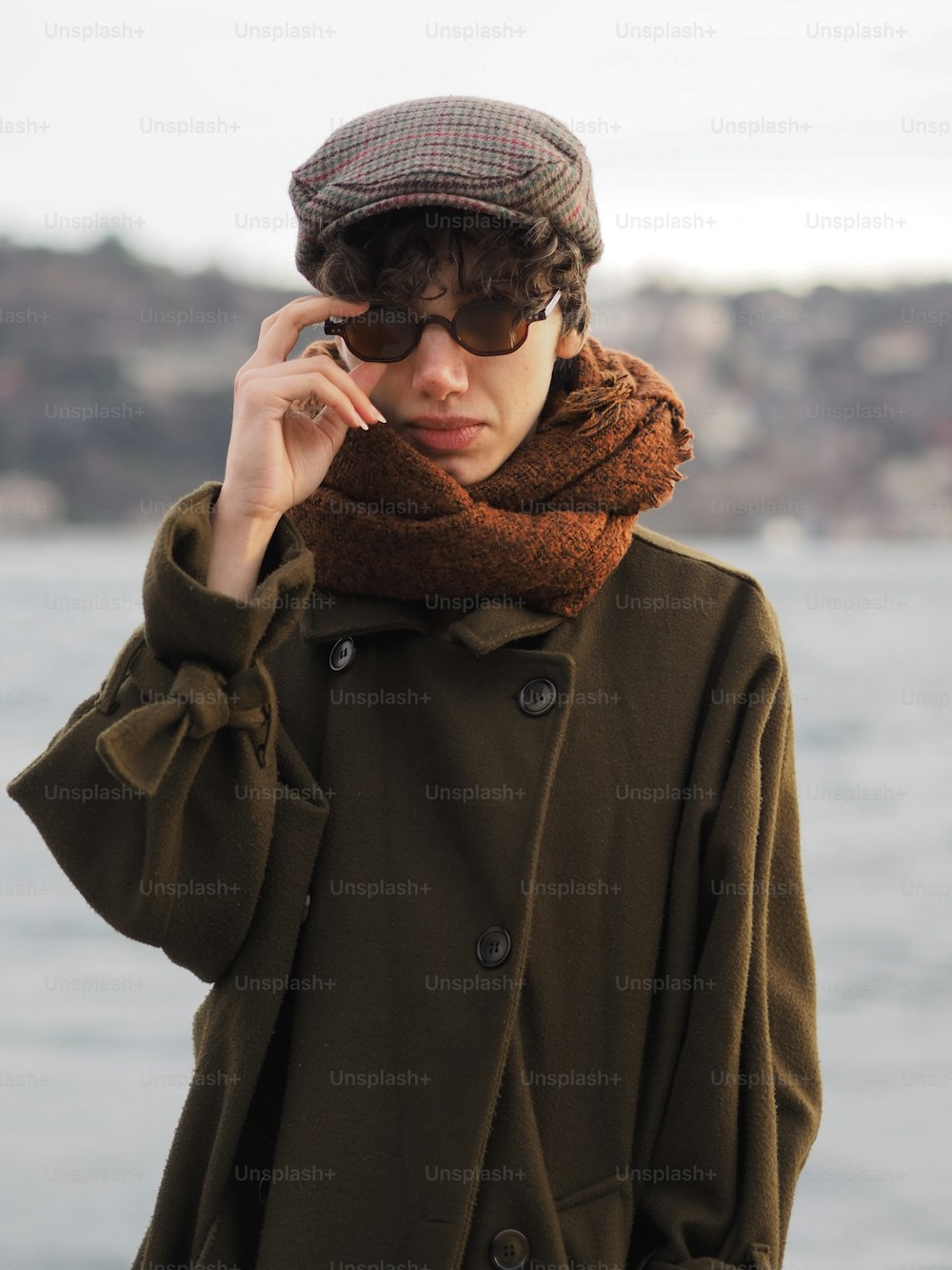a woman wearing a hat and scarf talking on a cell phone