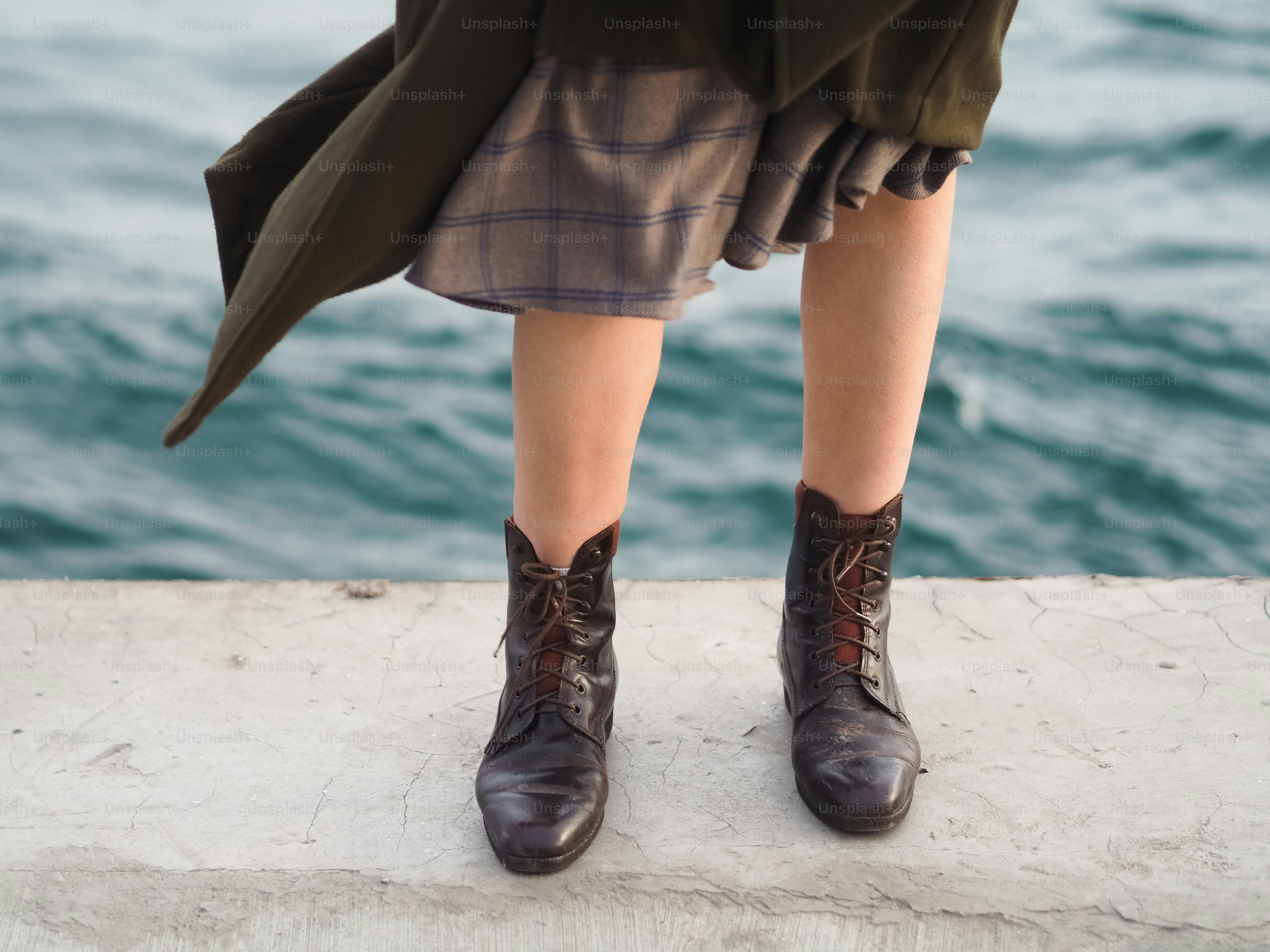 a close up of a person wearing brown shoes