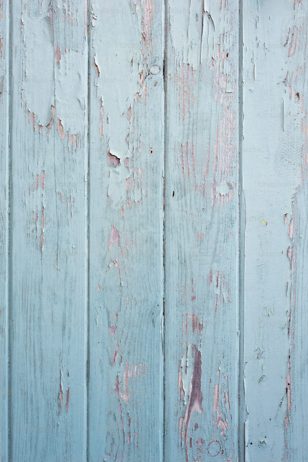 an old wooden wall with peeling paint on it