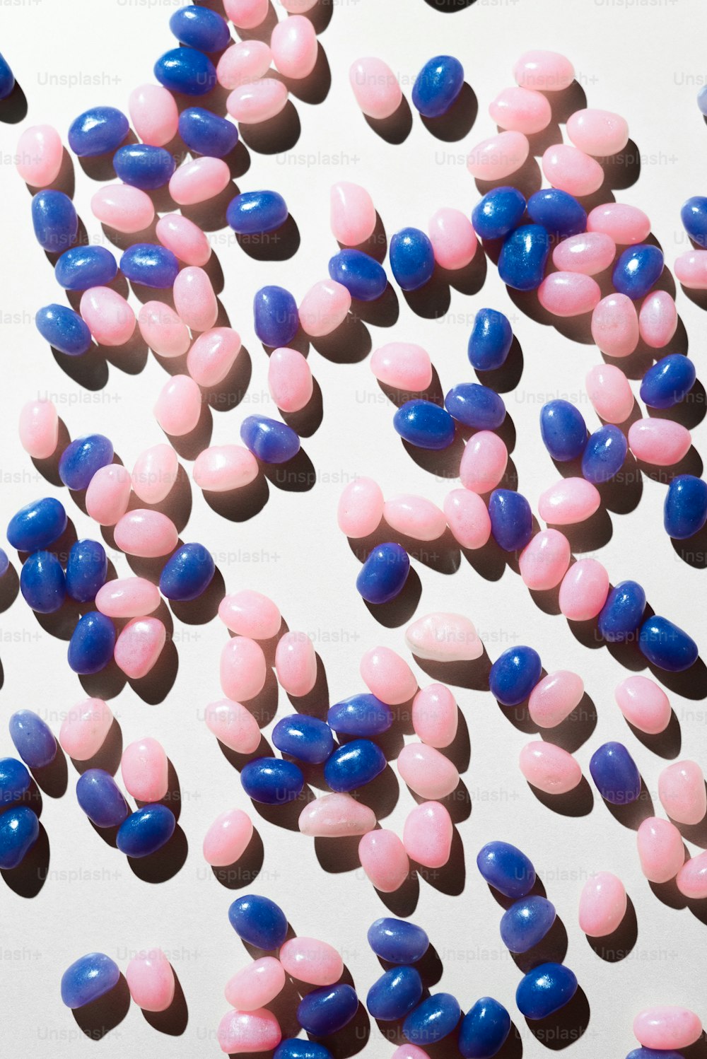 a large group of pink and blue pills
