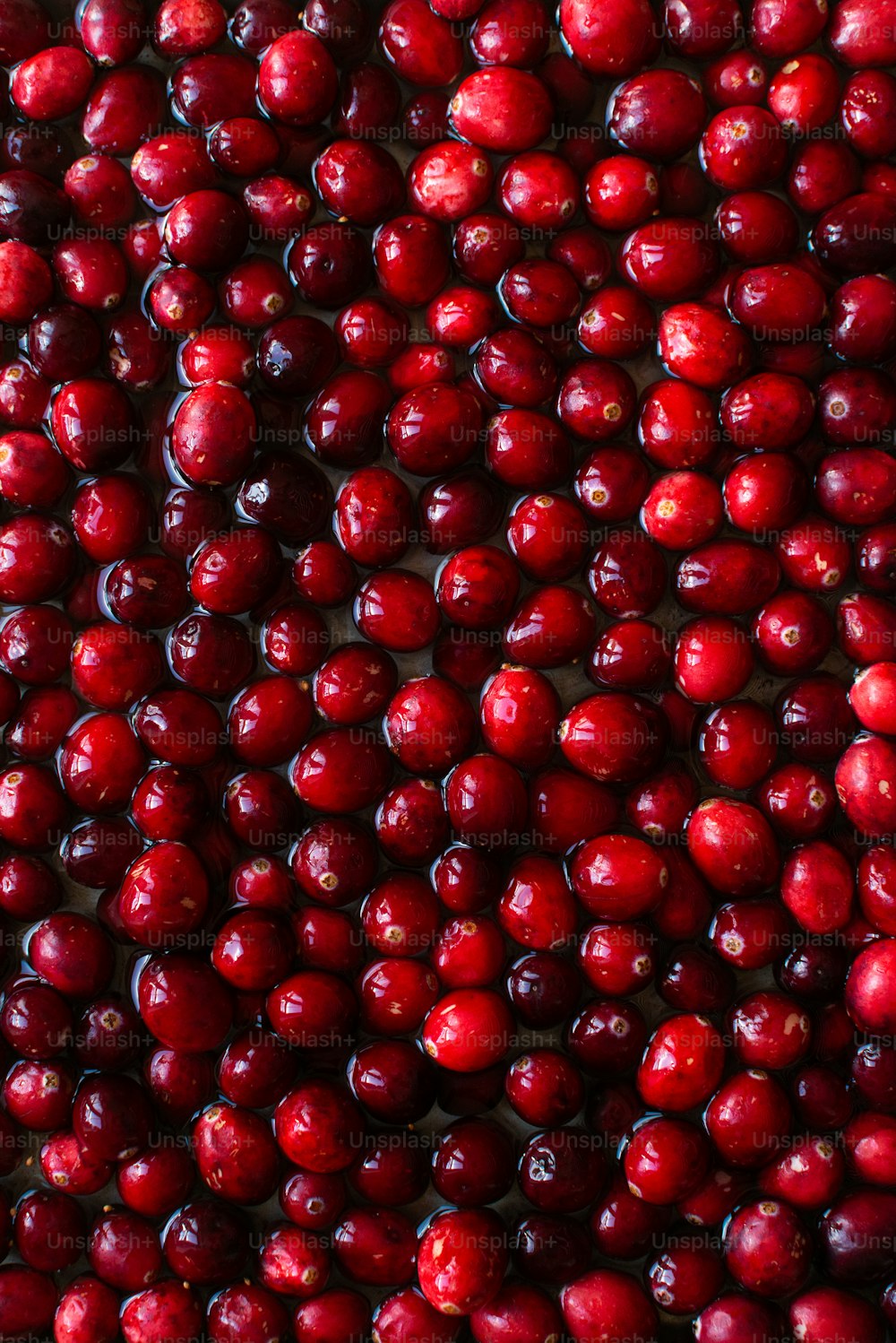 a pile of cranberries sitting on top of a table