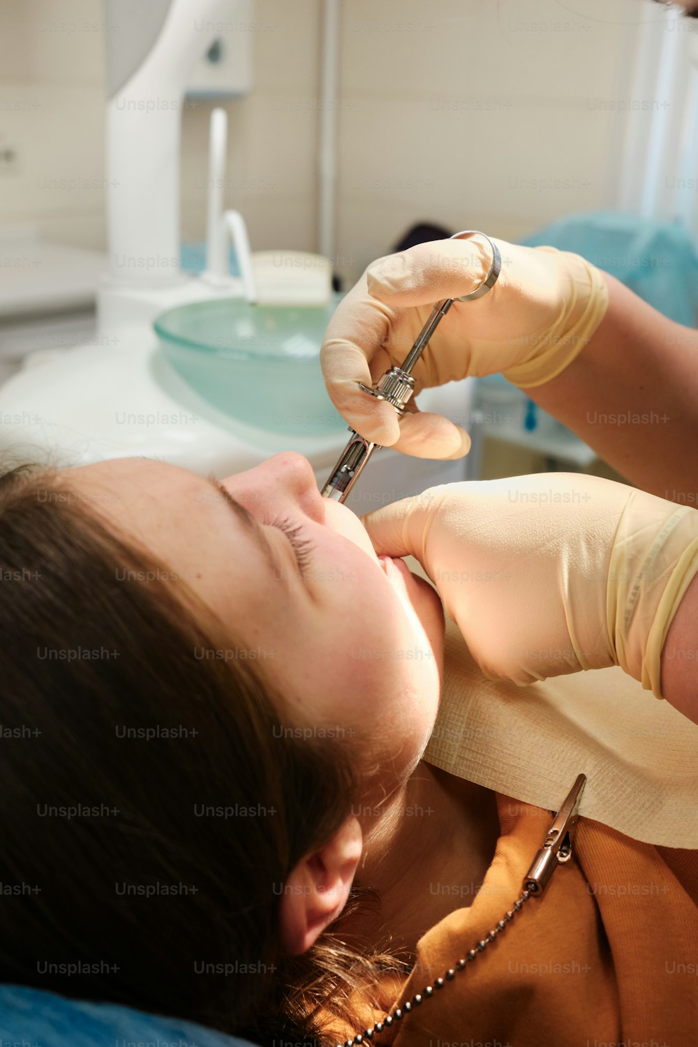 a woman getting her teeth checked by a dentist