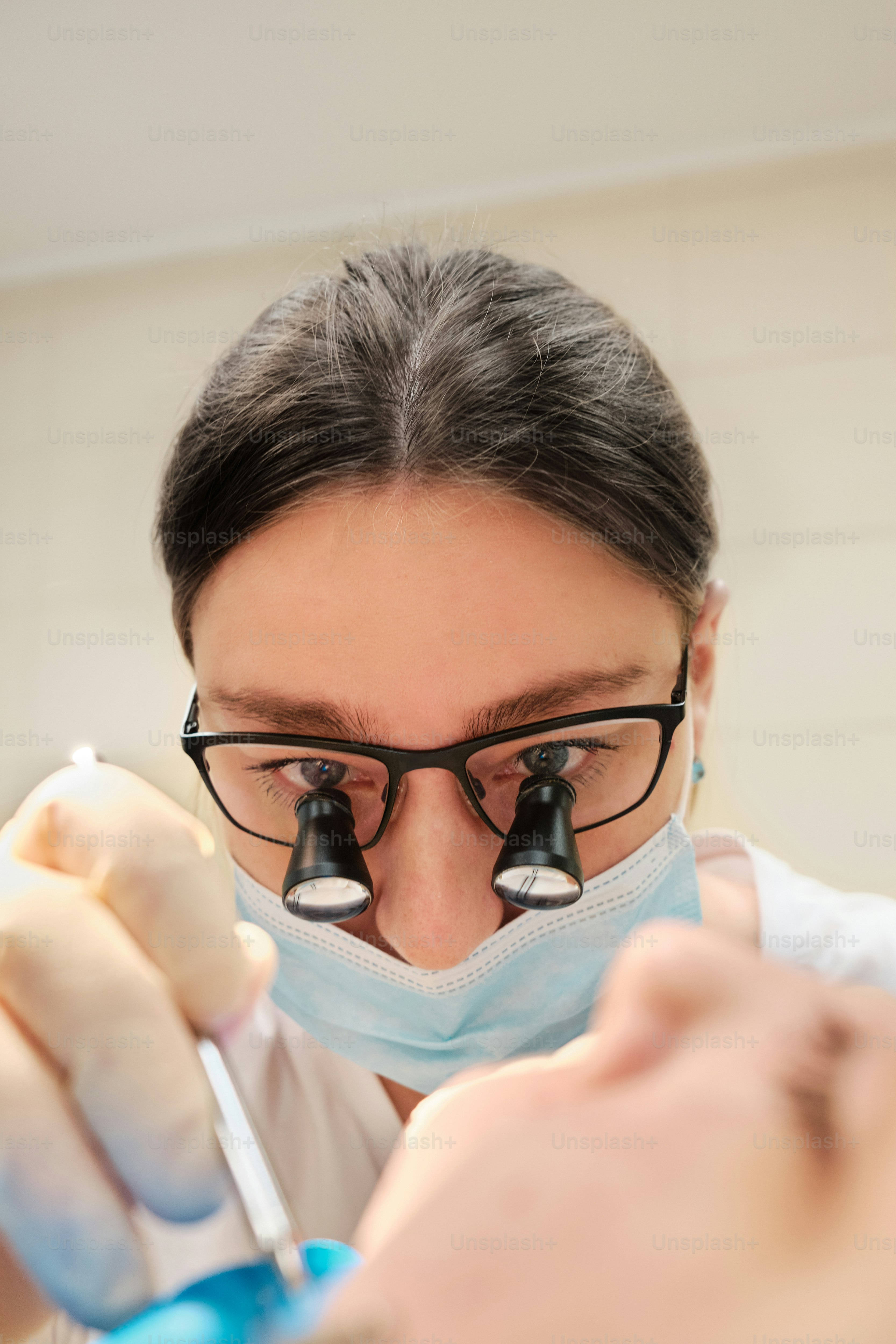 A woman wearing a surgical mask and holding a toothbrush photo ...