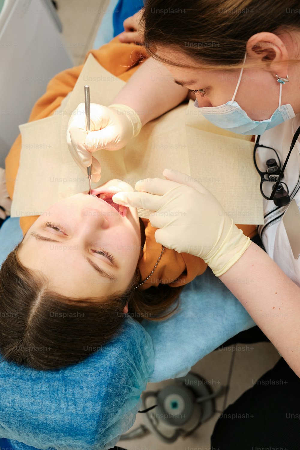 une femme qui fait vérifier ses dents par un dentiste