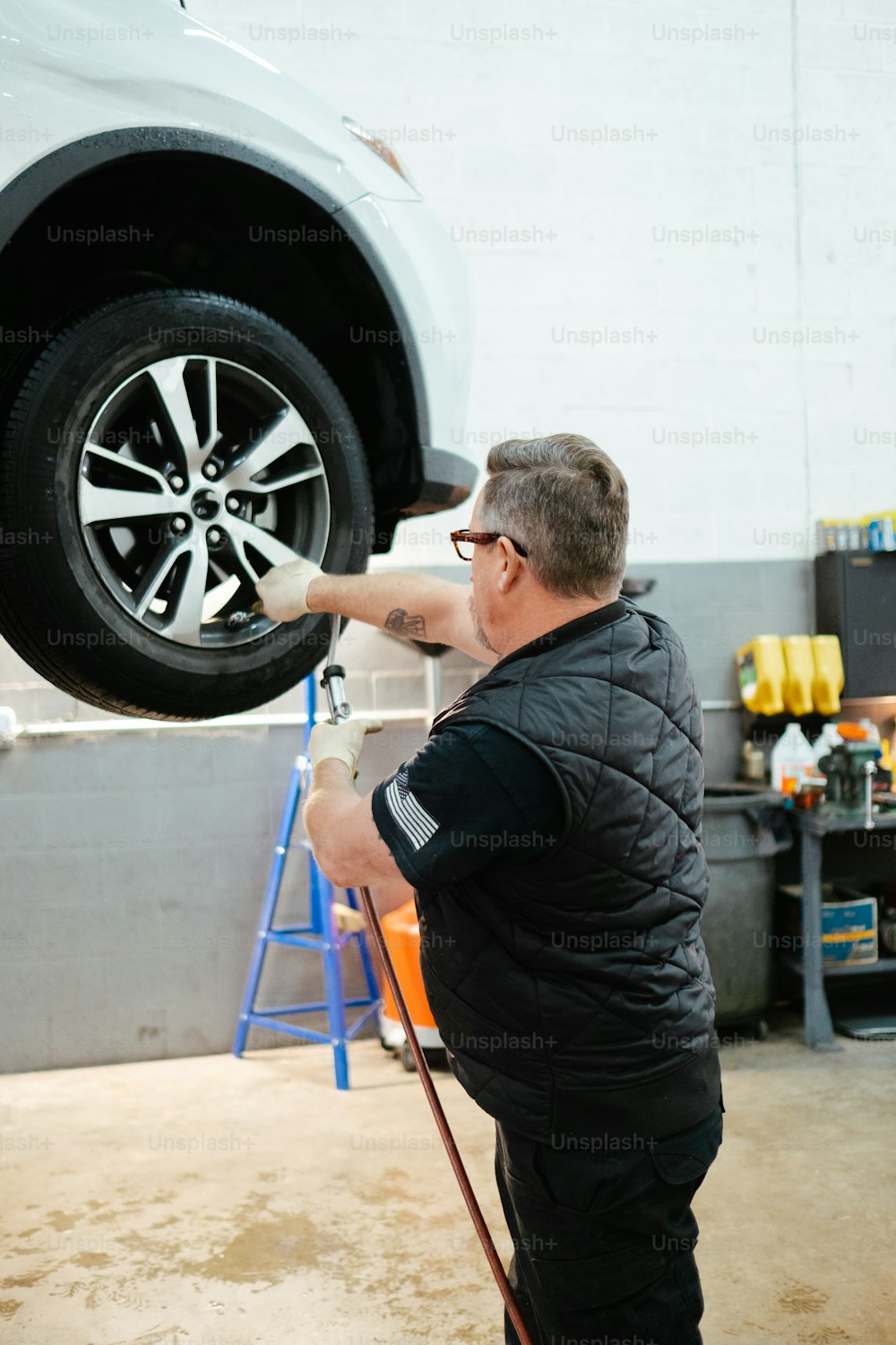 a man working on a car in a garage