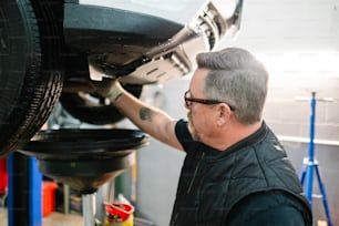a man working on a car in a garage