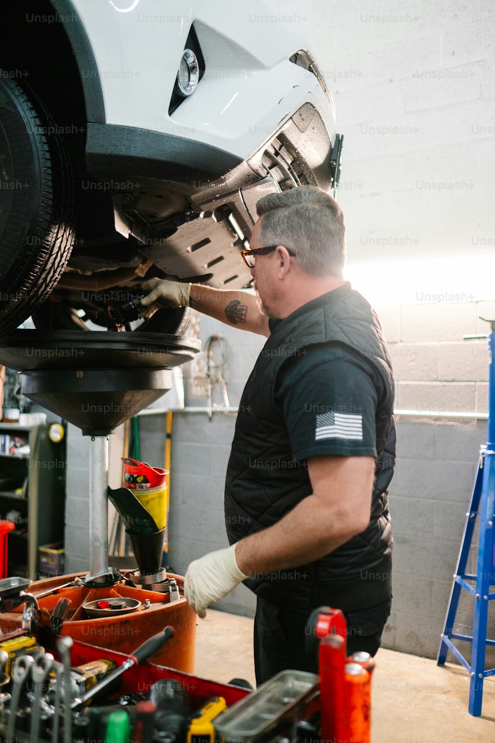 a man working on a car in a garage