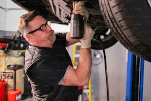 a man working on a car in a garage