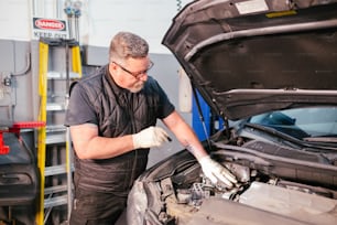 a man working on a car in a garage