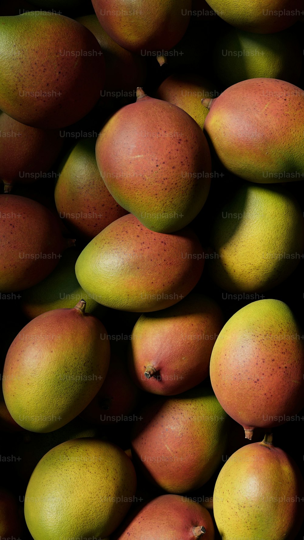 a pile of mangoes sitting on top of each other