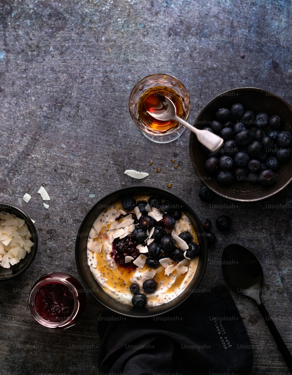 a bowl of oatmeal with blueberries and a glass of wine