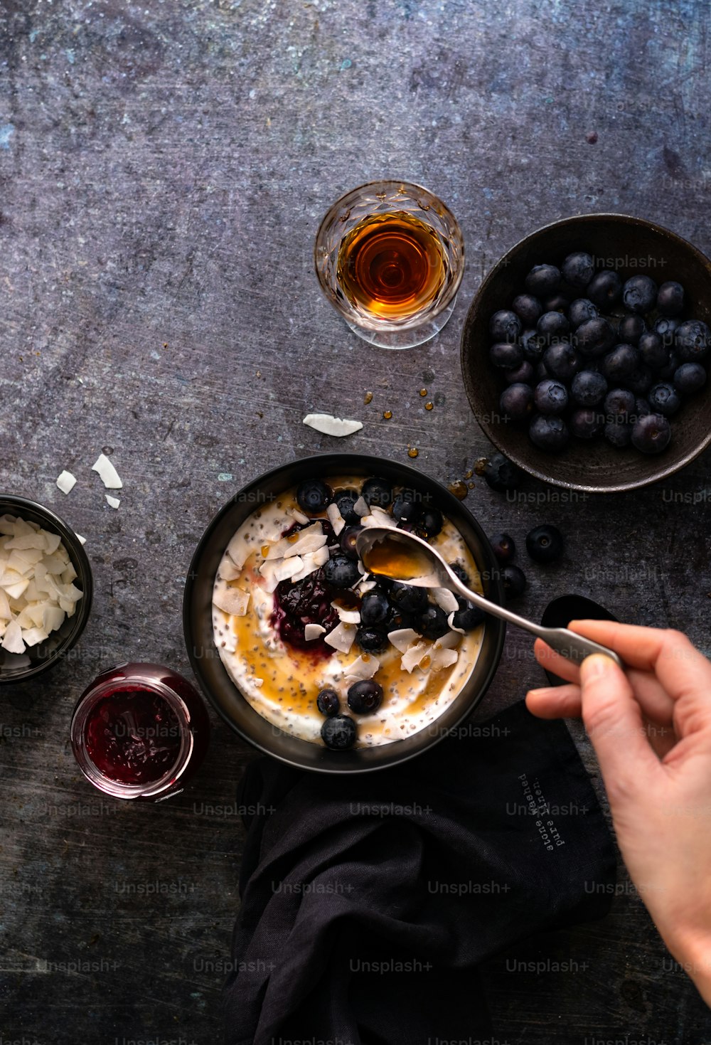 a bowl of oatmeal with blueberries and a spoon