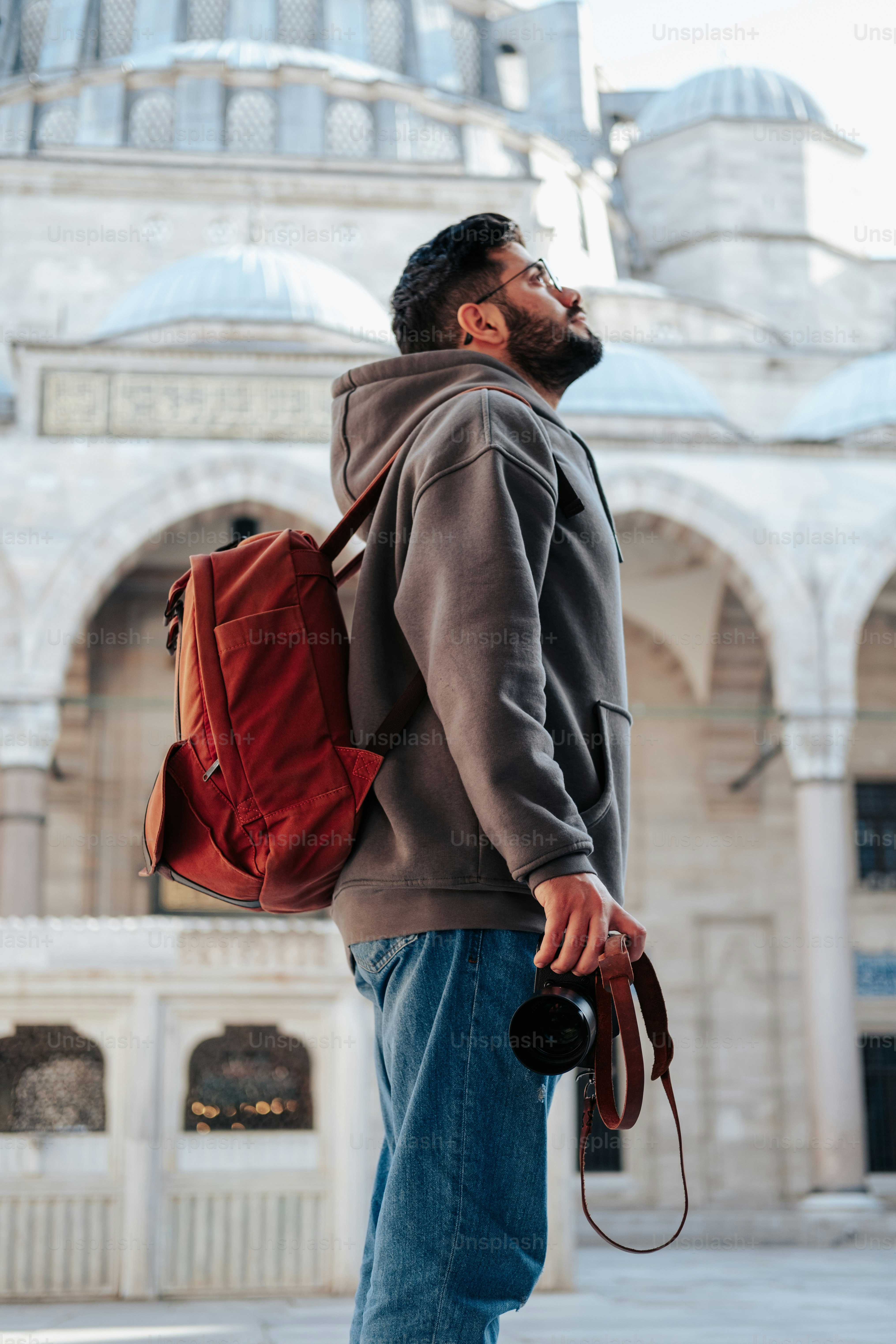 a man with a backpack and a camera