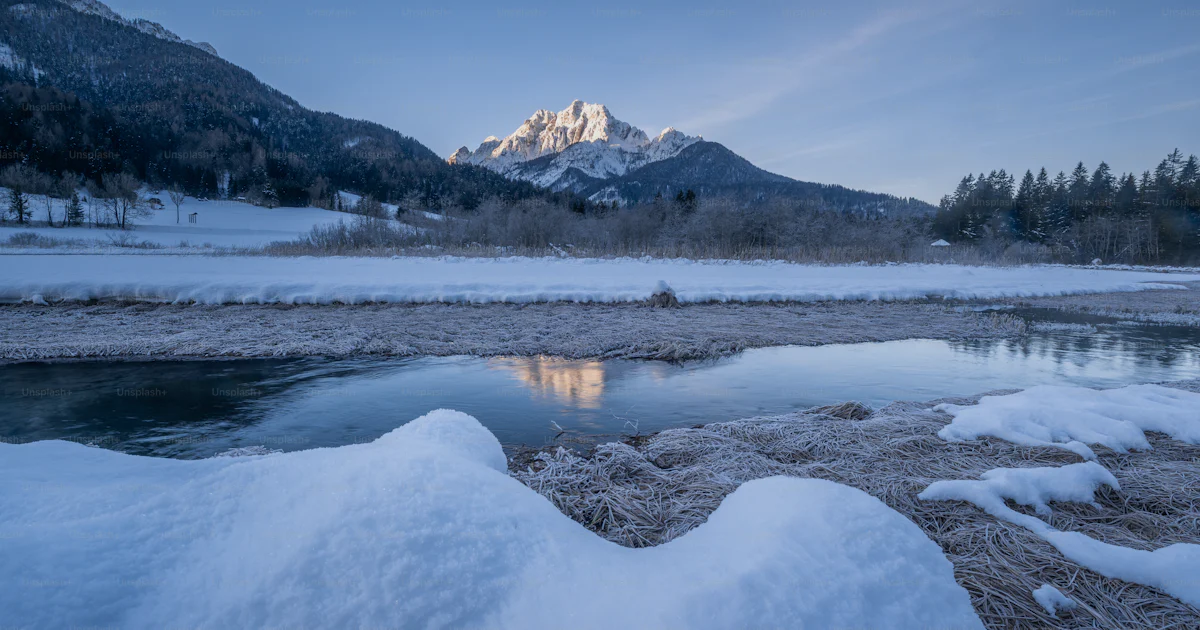 Source Splash Snow Image A river with snow on the ground and mountains in the background photo ...
