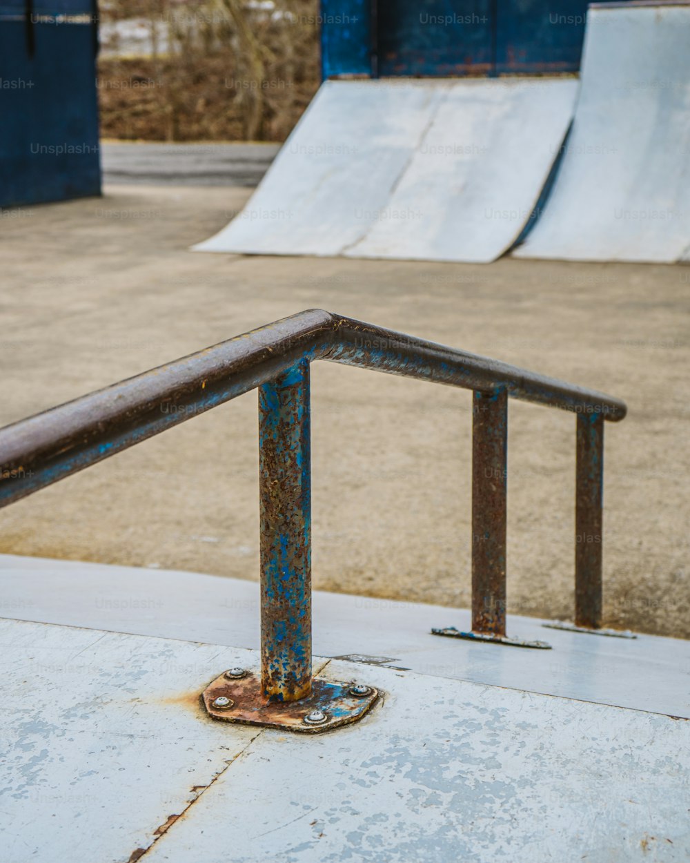 a skateboard park with a metal railing and a skateboard ramp
