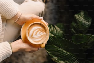 a woman holding a cup of coffee in her hands