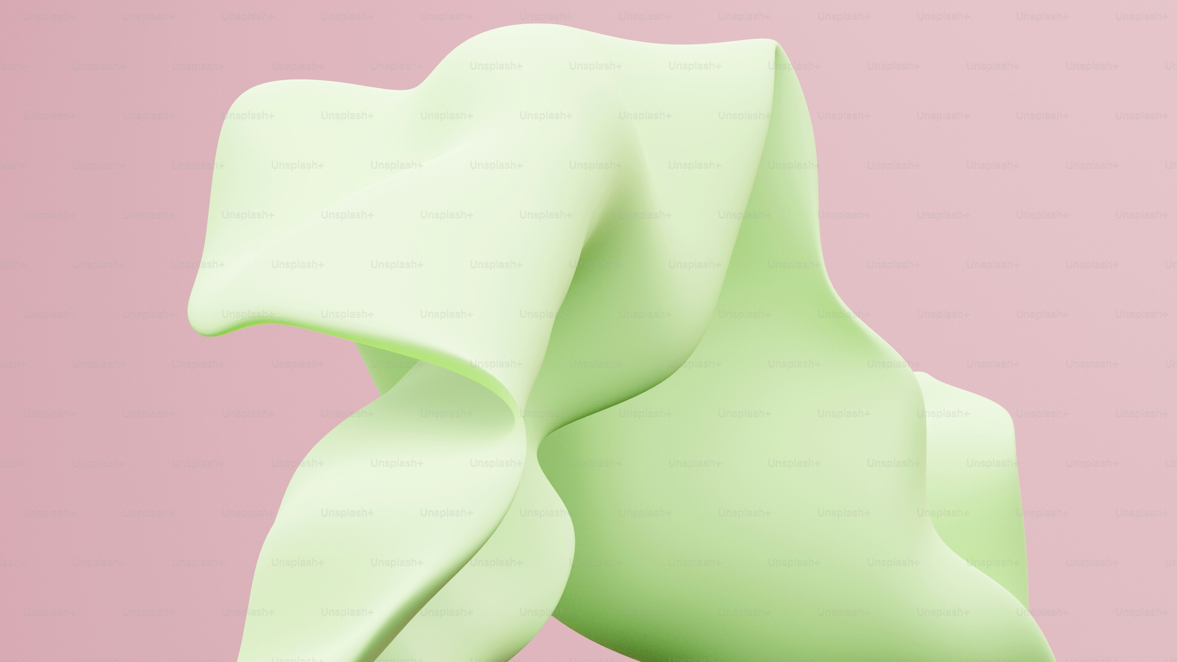 a close up of a green object on a pink background