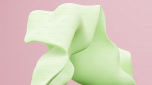 eine Nahaufnahme eines grünen Objekts auf rosa Hintergrund