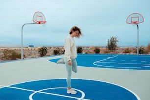 a woman standing on top of a basketball court
