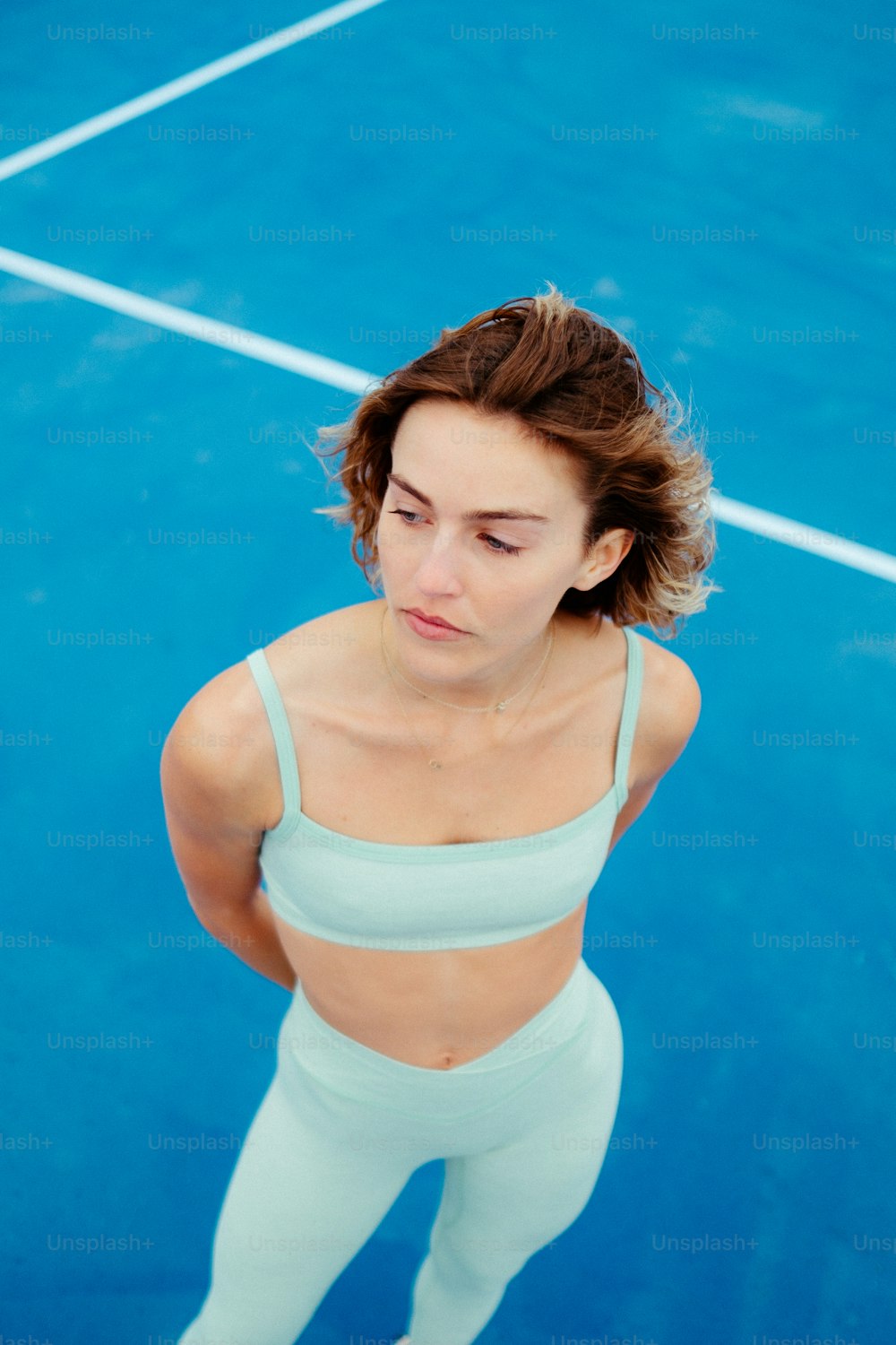 a woman standing on a tennis court holding a racquet