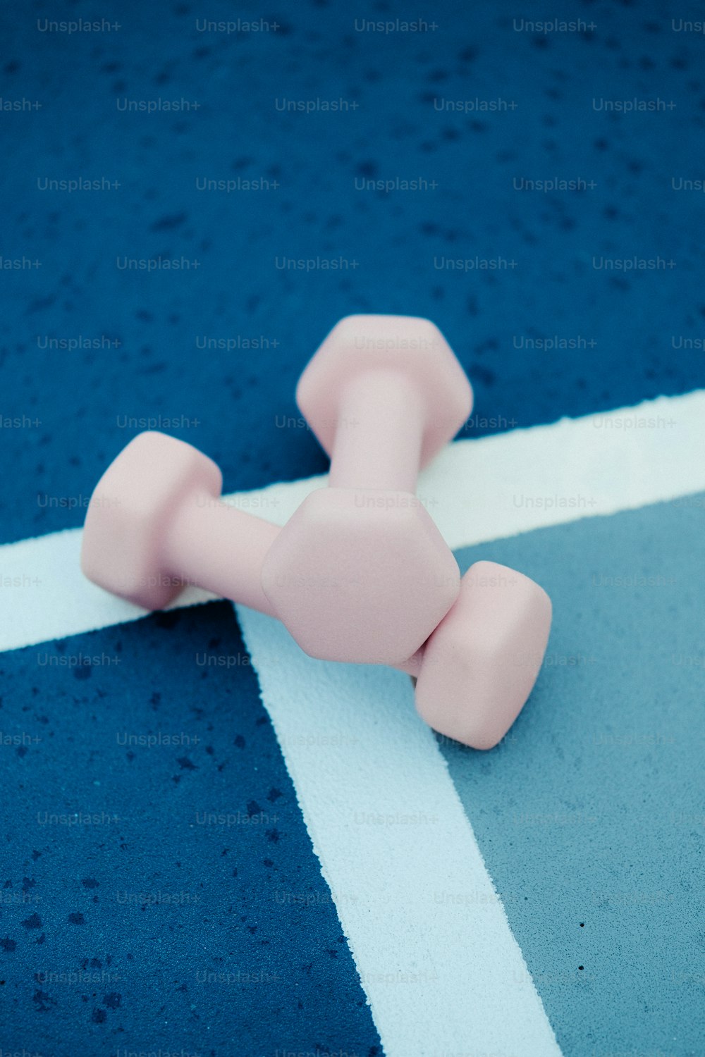 a pink object on a blue and white surface