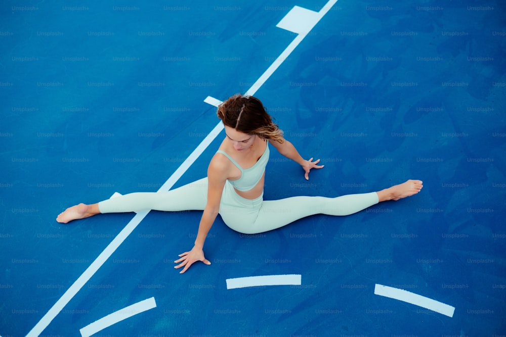 a woman is sitting on a tennis court