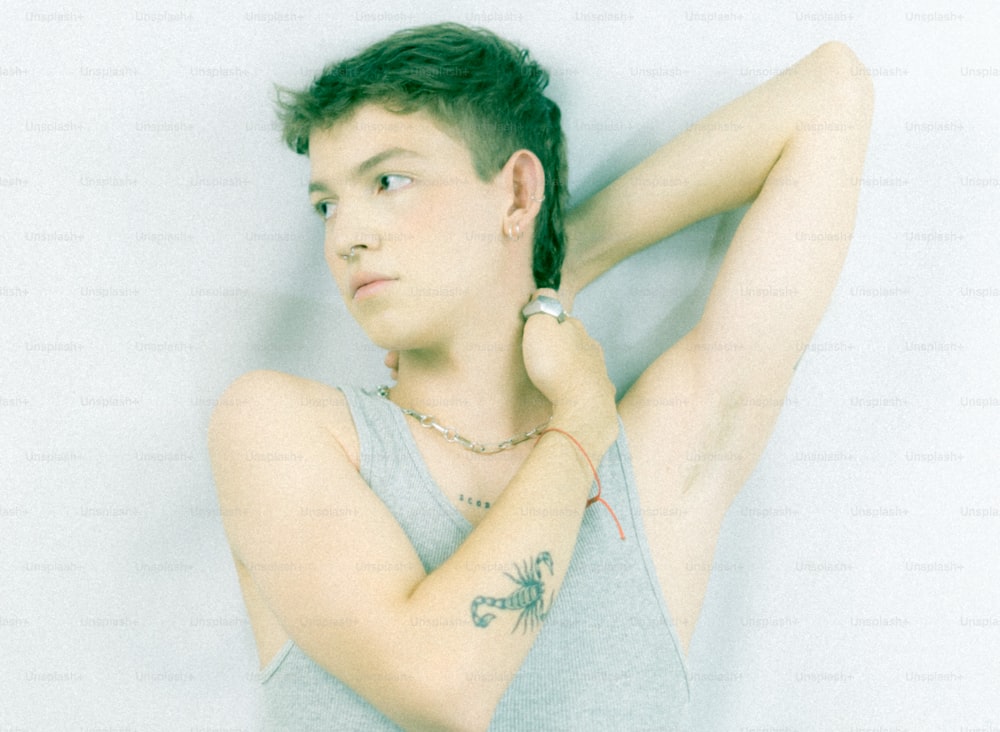 a young man with a tattoo on his arm