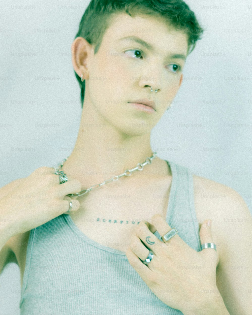 a young man is putting on a necklace