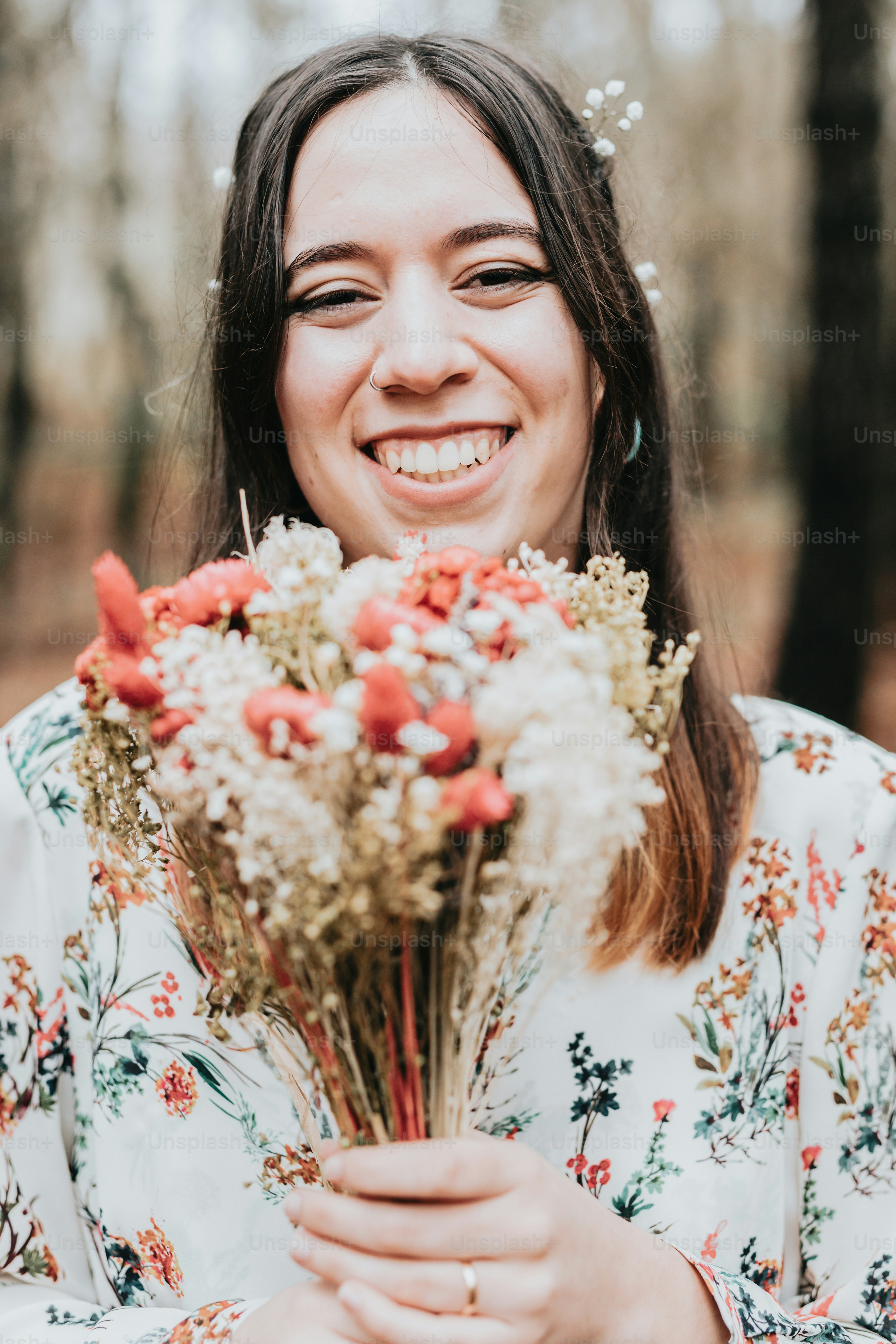 A woman holding a bunch of flowers in her hands photo – Bride Image on ...