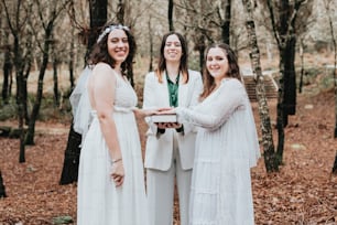 a group of women standing next to each other in a forest