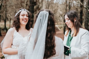 a bride smiles as she looks at her friend