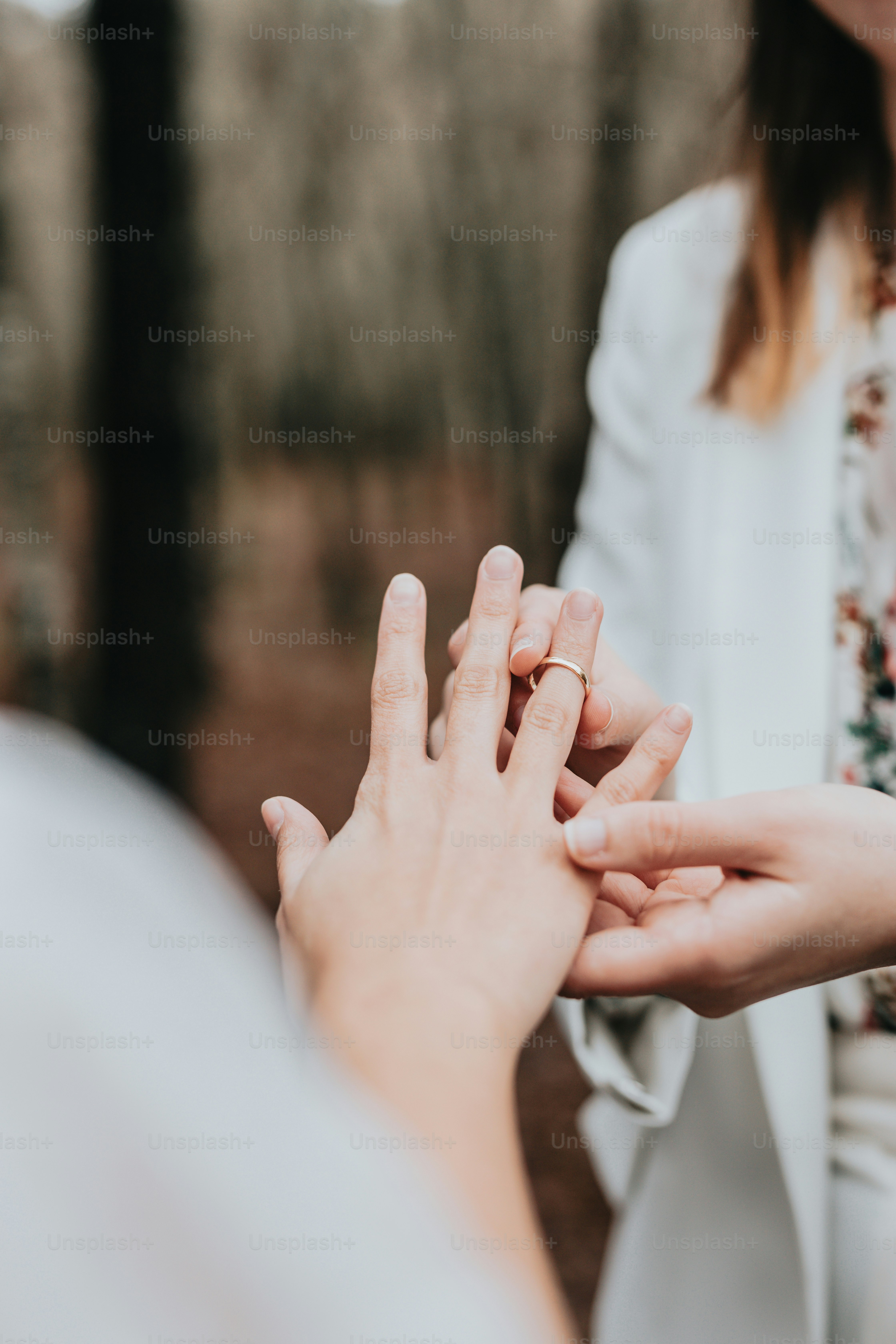 a person holding another person's hand in a forest