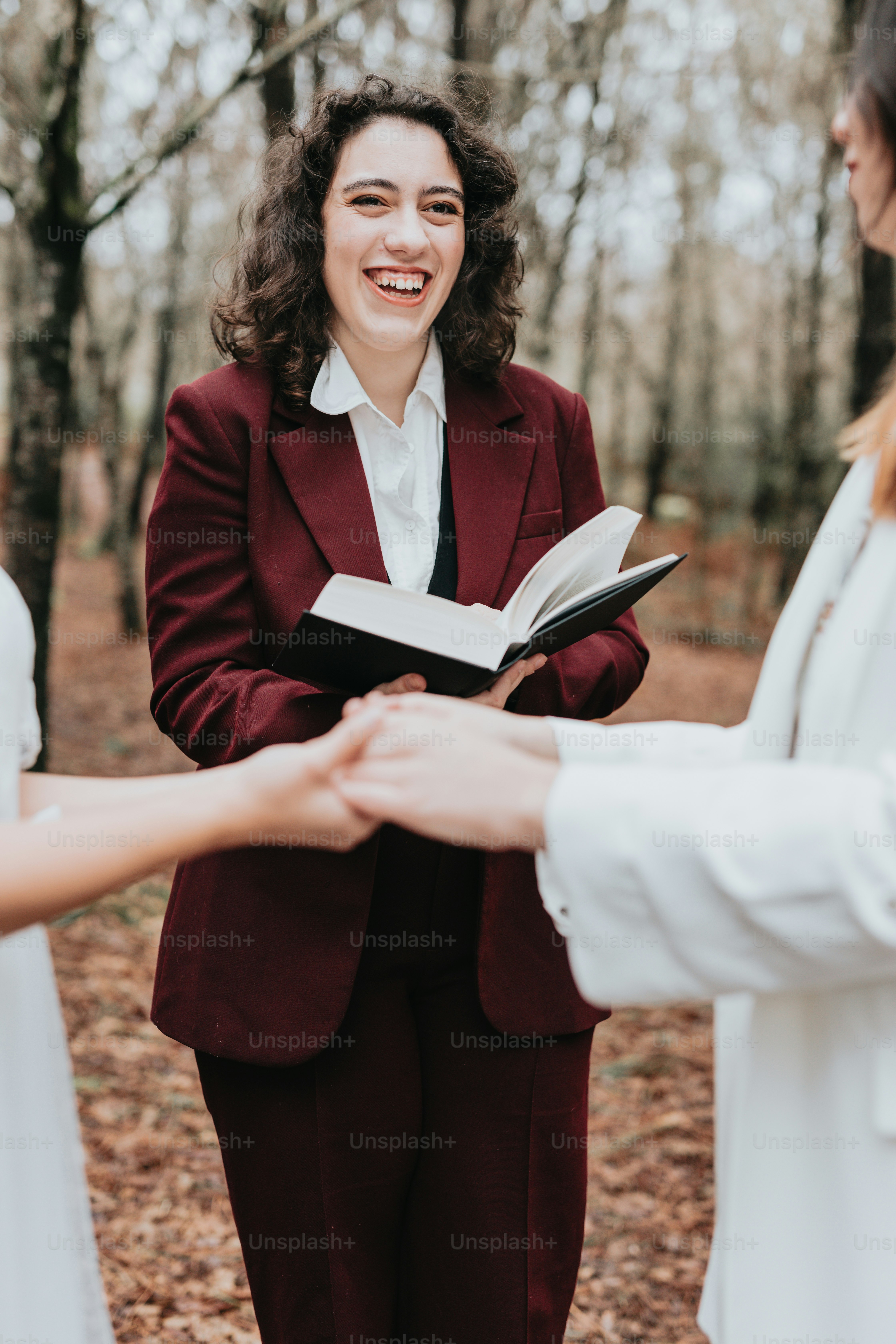 a woman in a red suit holding a book