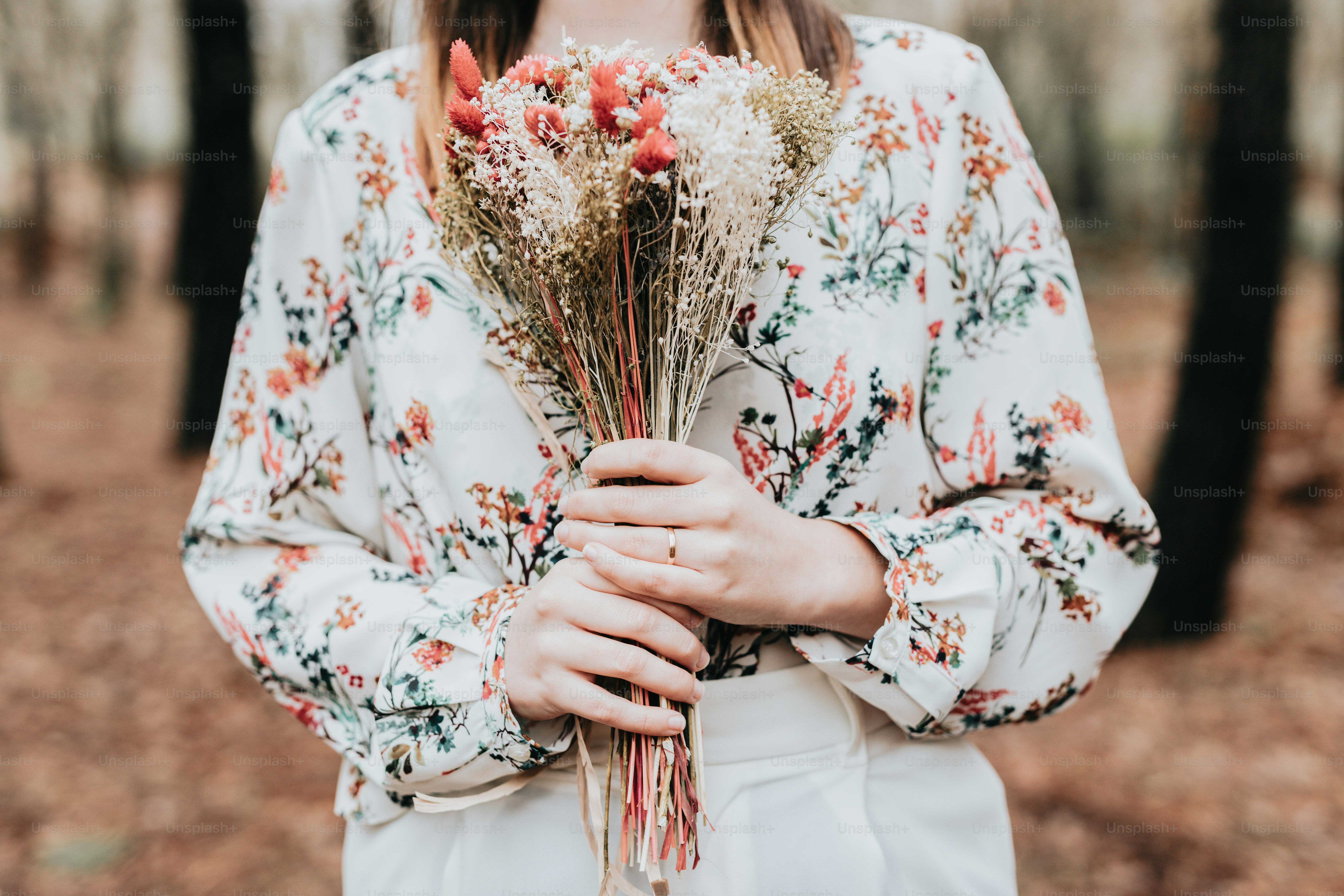 A woman holding a bunch of flowers in her hands photo – Forest Image on ...