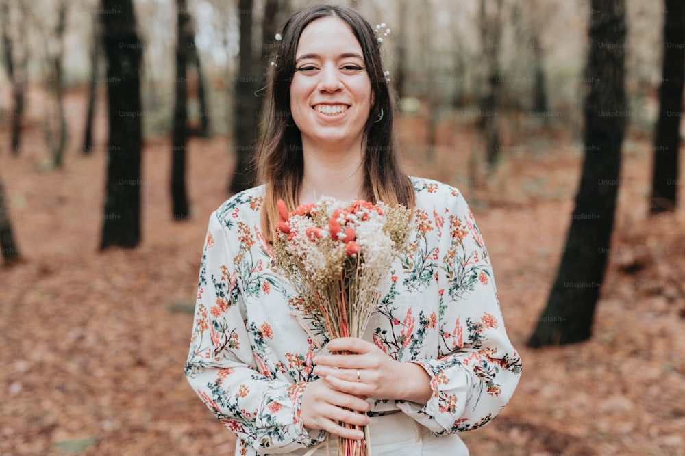 a woman standing in a forest holding a bouquet of flowers