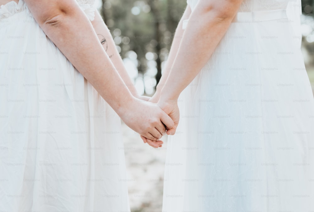 a couple holding hands while standing next to each other