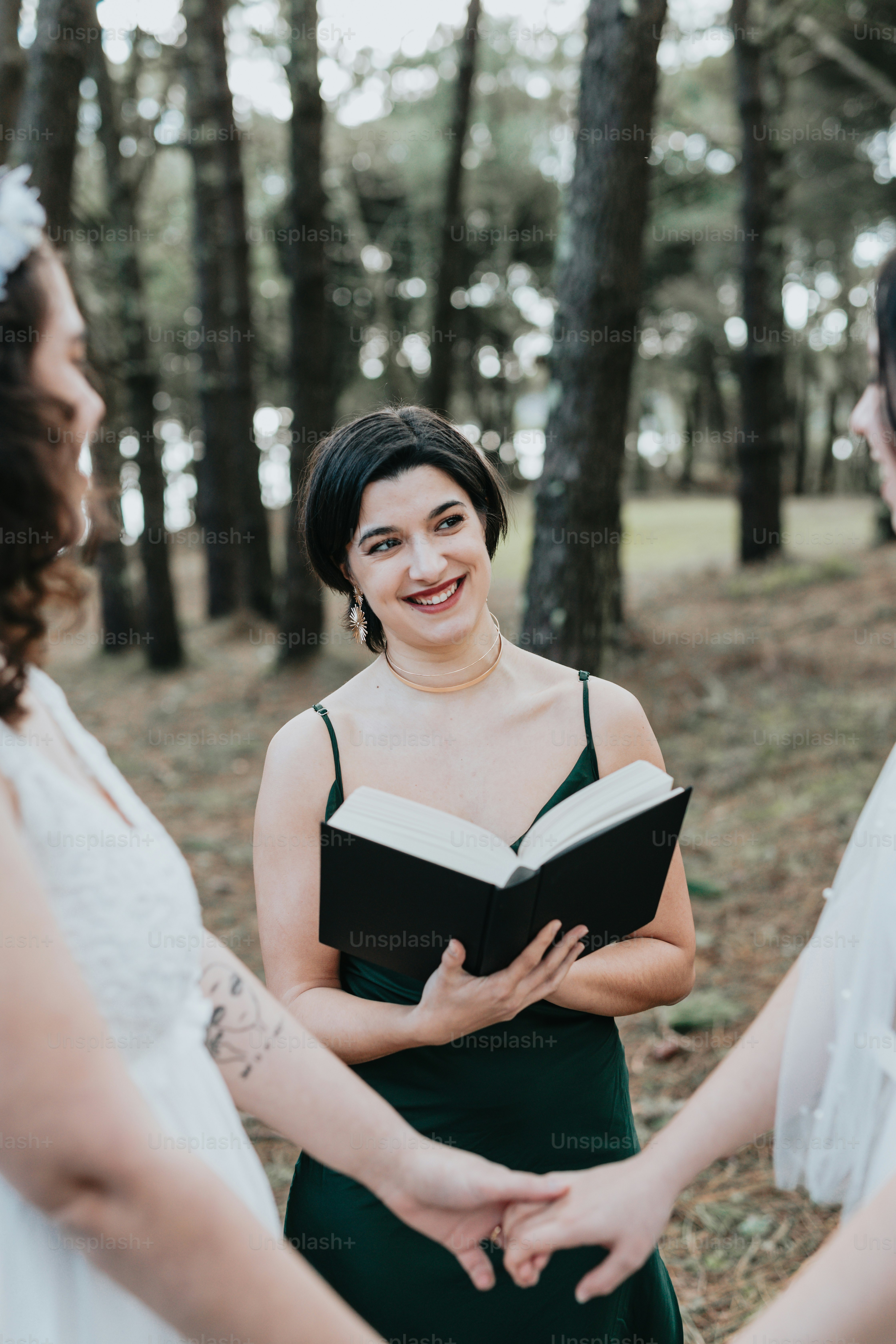 a woman in a green dress holding a book