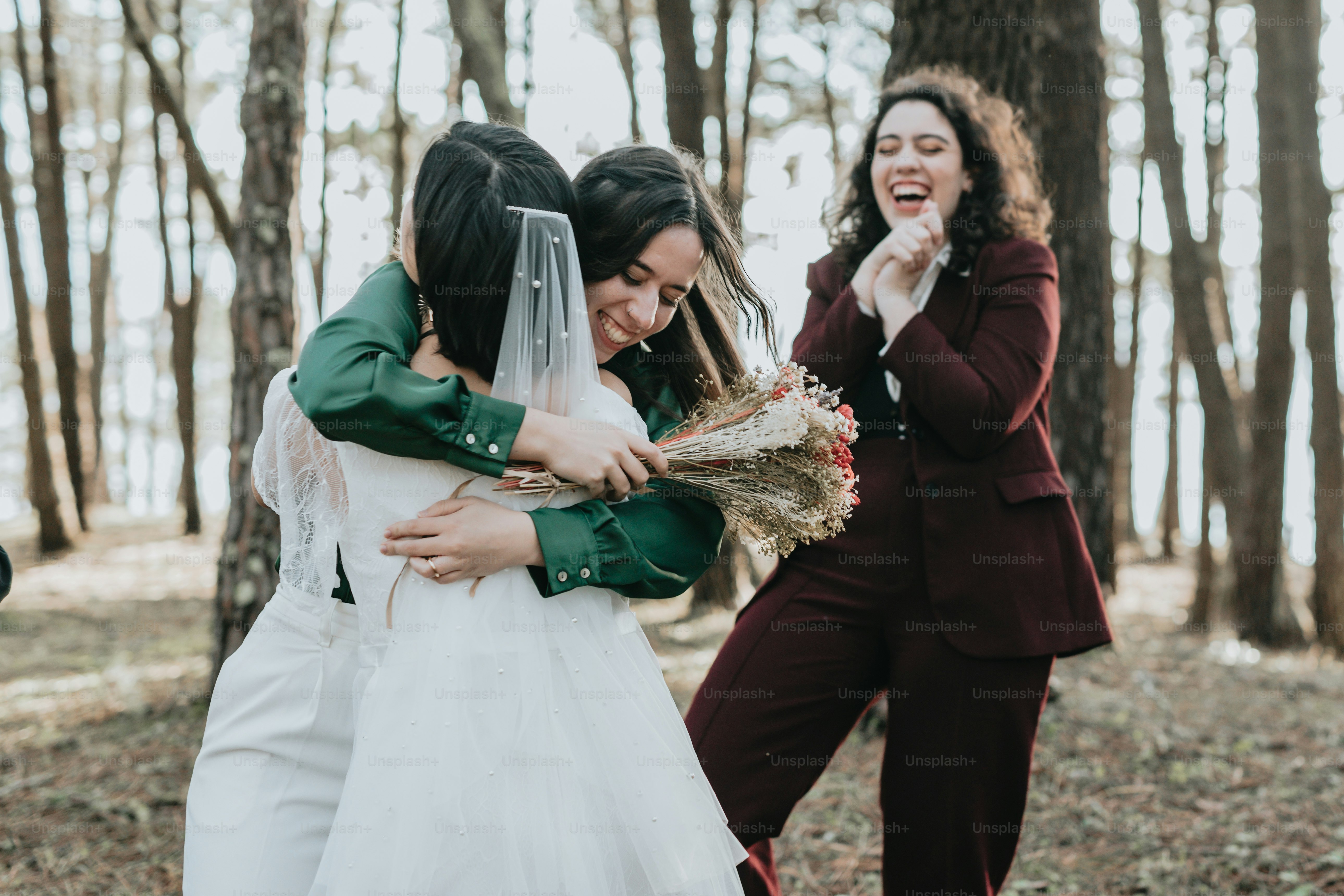 A group of women standing around each other in a forest photo – Family ...