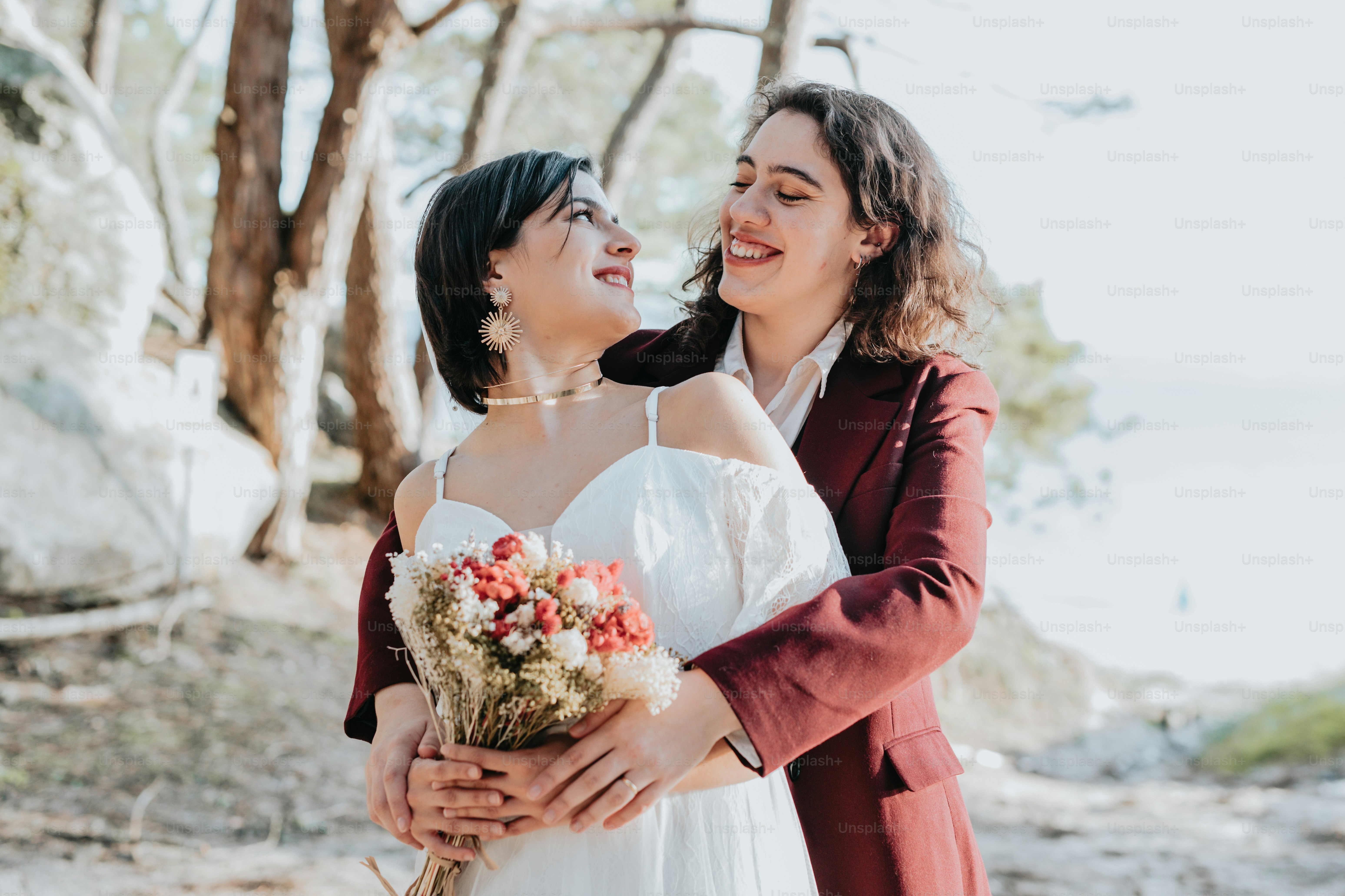 A couple of women hugging each other in the woods photo – Relation ...